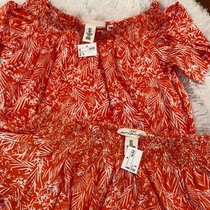 Bright orange top, with floral designs.